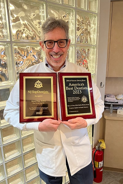 Dr Fine holding awards